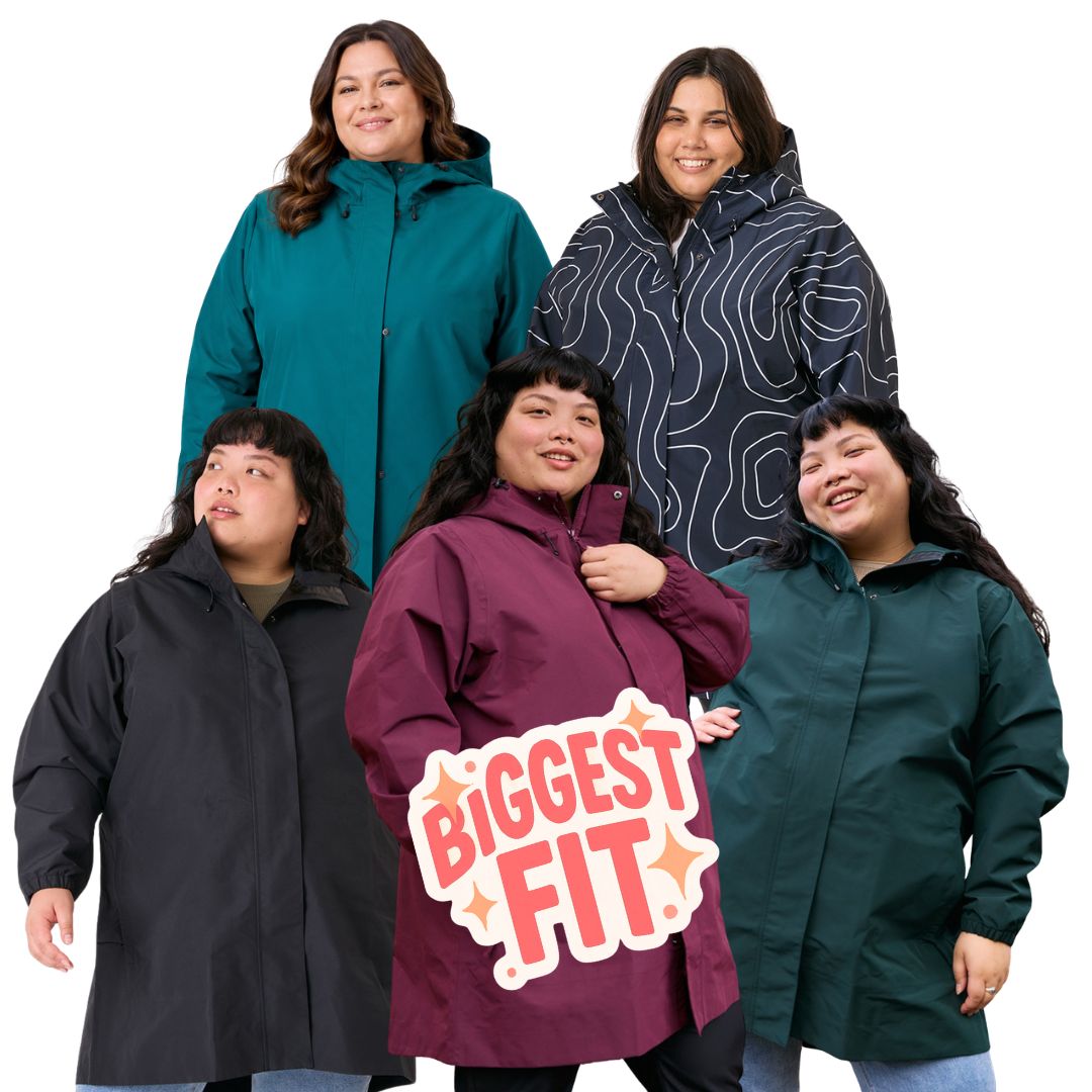 Five plus-size women modeling oversized Amble Refuge rain jackets in different colours against a white background, with a 'BIGGEST FIT' graphic overlay in the center.
