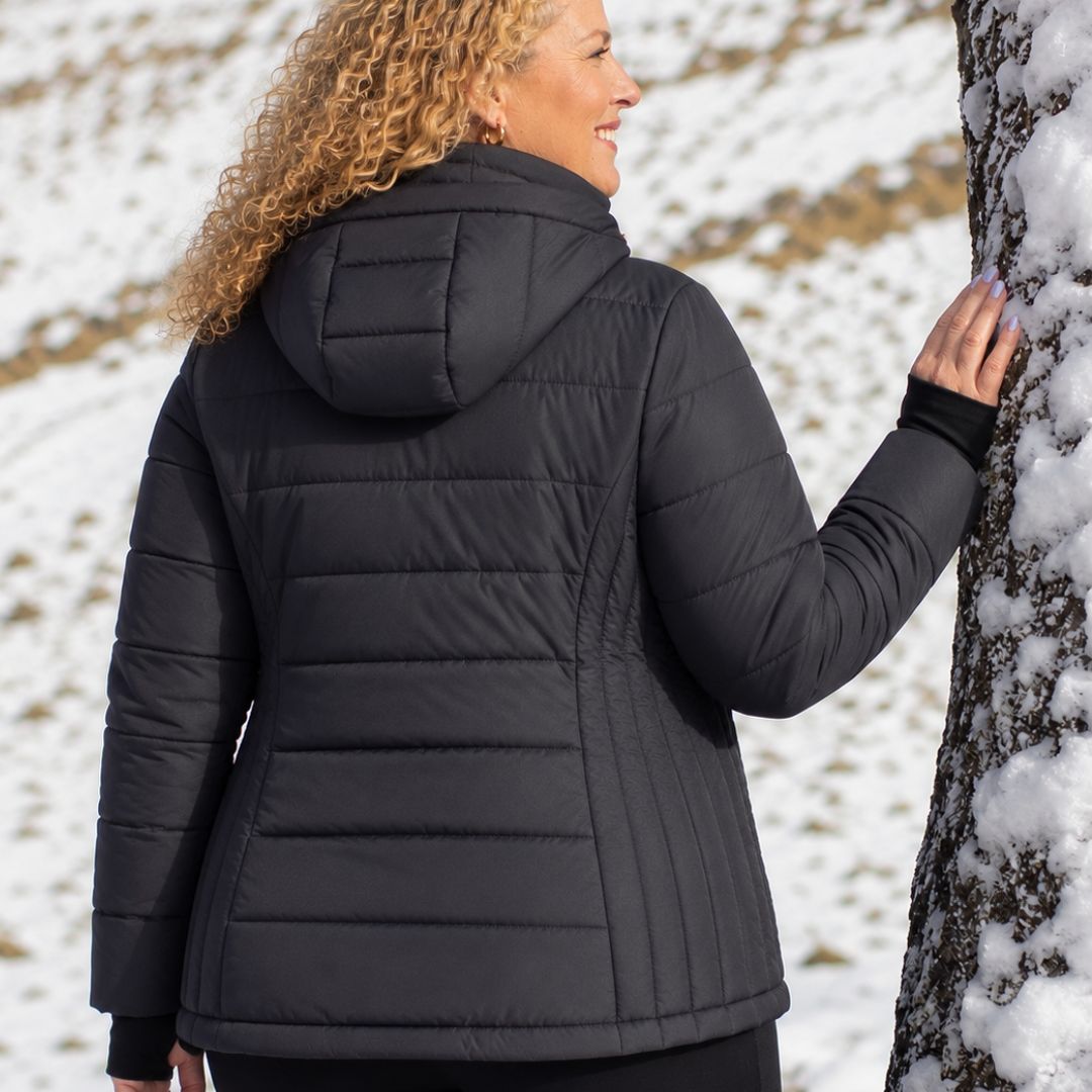Rear view of a woman looking over her shoulder showcasing the back fit of the black Moke Luciana Women's Down Puffer Jacket.