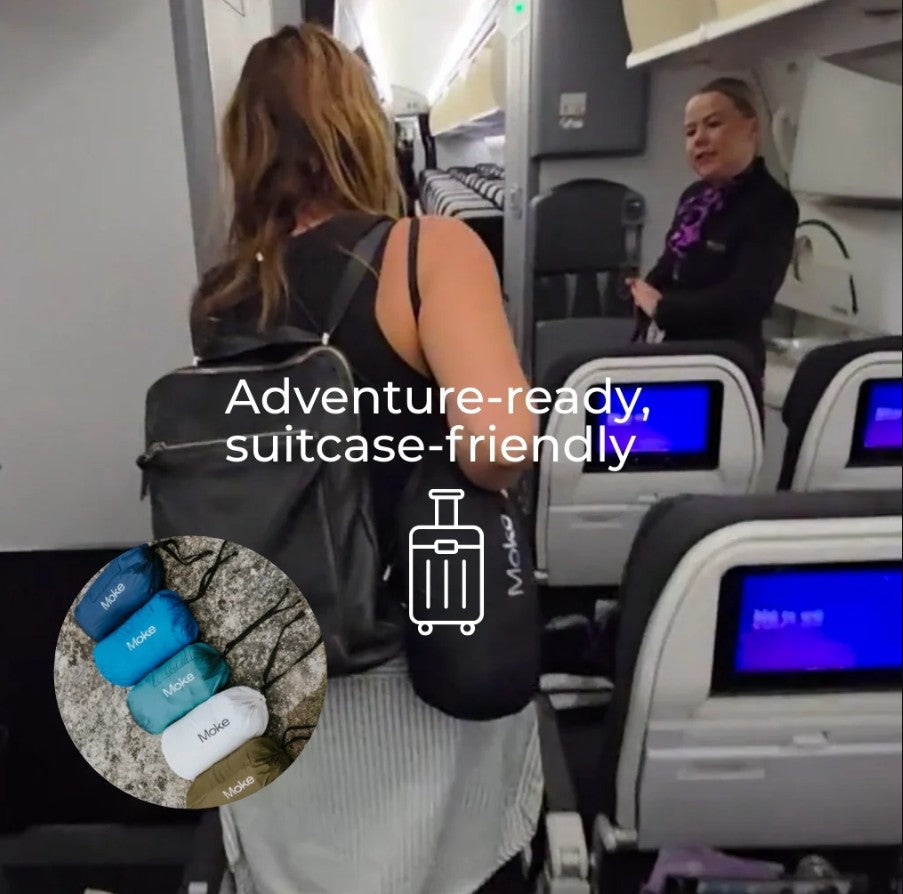 Woman wearing Moke packable jacket on the plane.