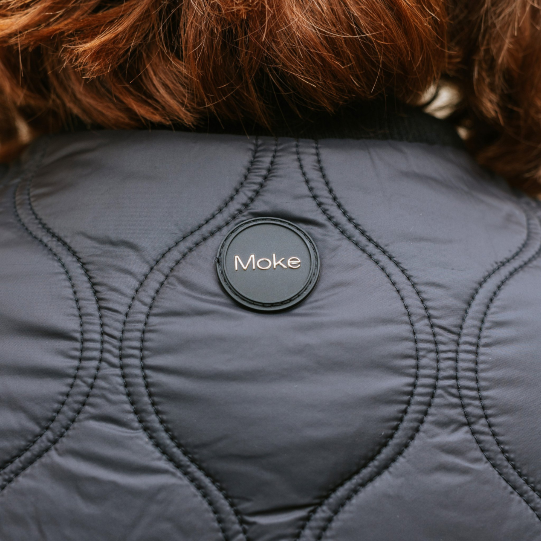 Back design for talei quilt bomber black, also showing the moke brand