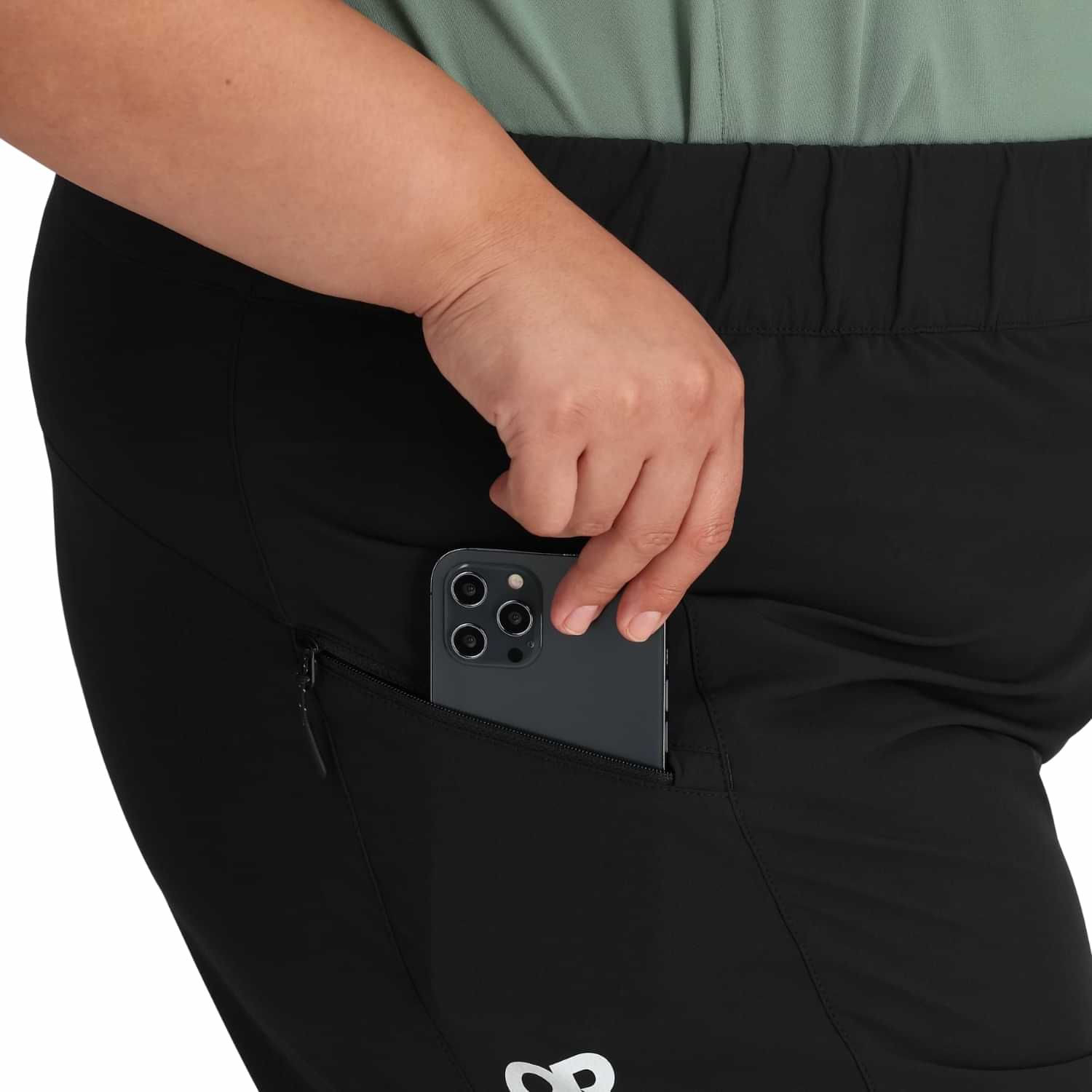 Close-up of Outdoor Research Freewheel Women’s Plus Size Shorts in black, featuring secure zip pocket and large cargo phone pocket for hiking, travel, and outdoor adventures.