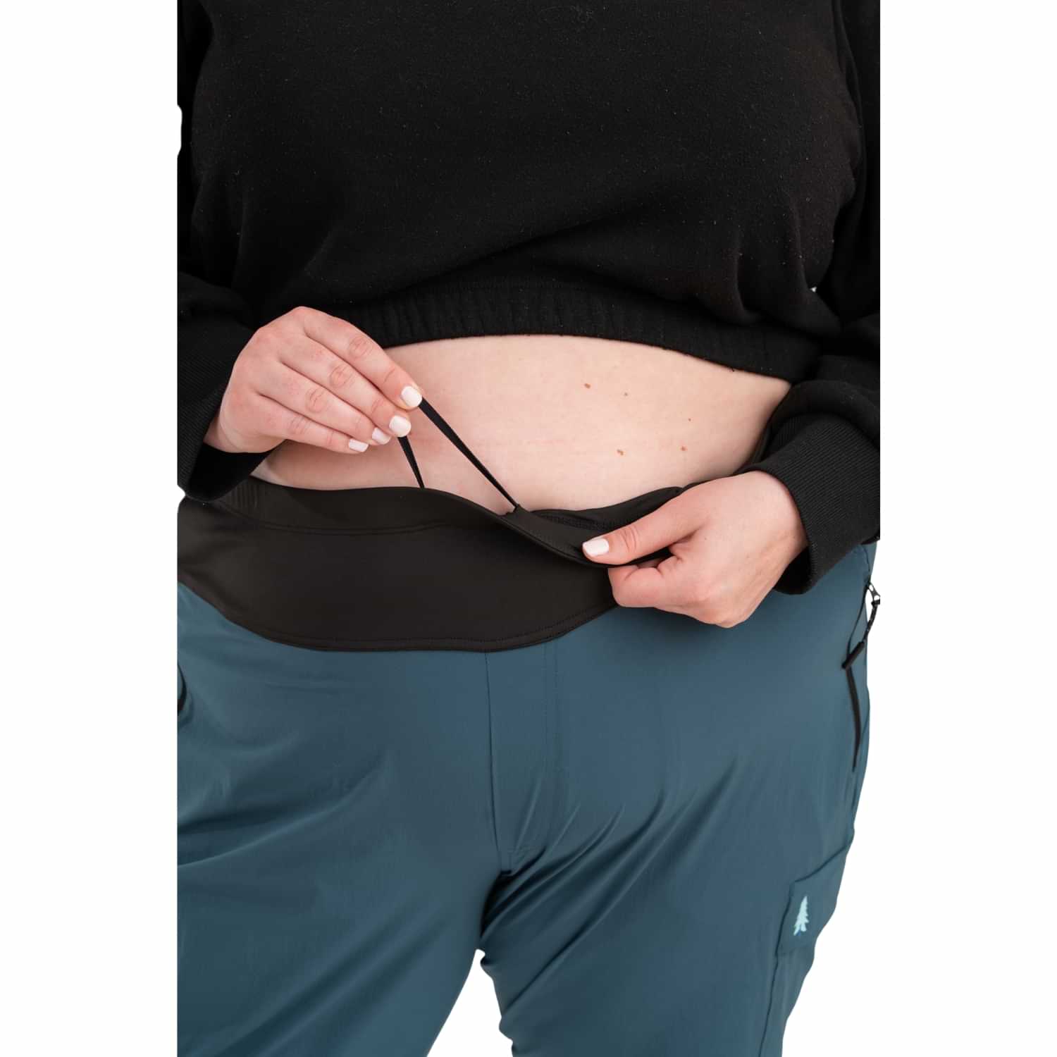 Close-up of Thicket Adventure Brecken Hiking Pants BOOTY FIT in blue, showing adjustable waistband and stretch comfort design for plus sizes 18-34.