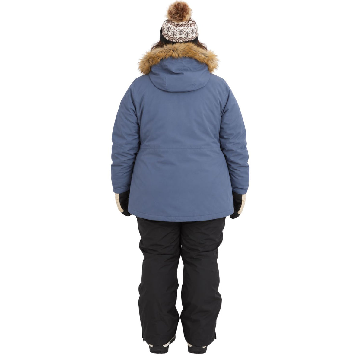 A person viewed from the back wearing a blue winter parka with a brown faux-fur trimmed hood, black snow pants, and a patterned knit beanie with a pom-pom, against a plain white background.