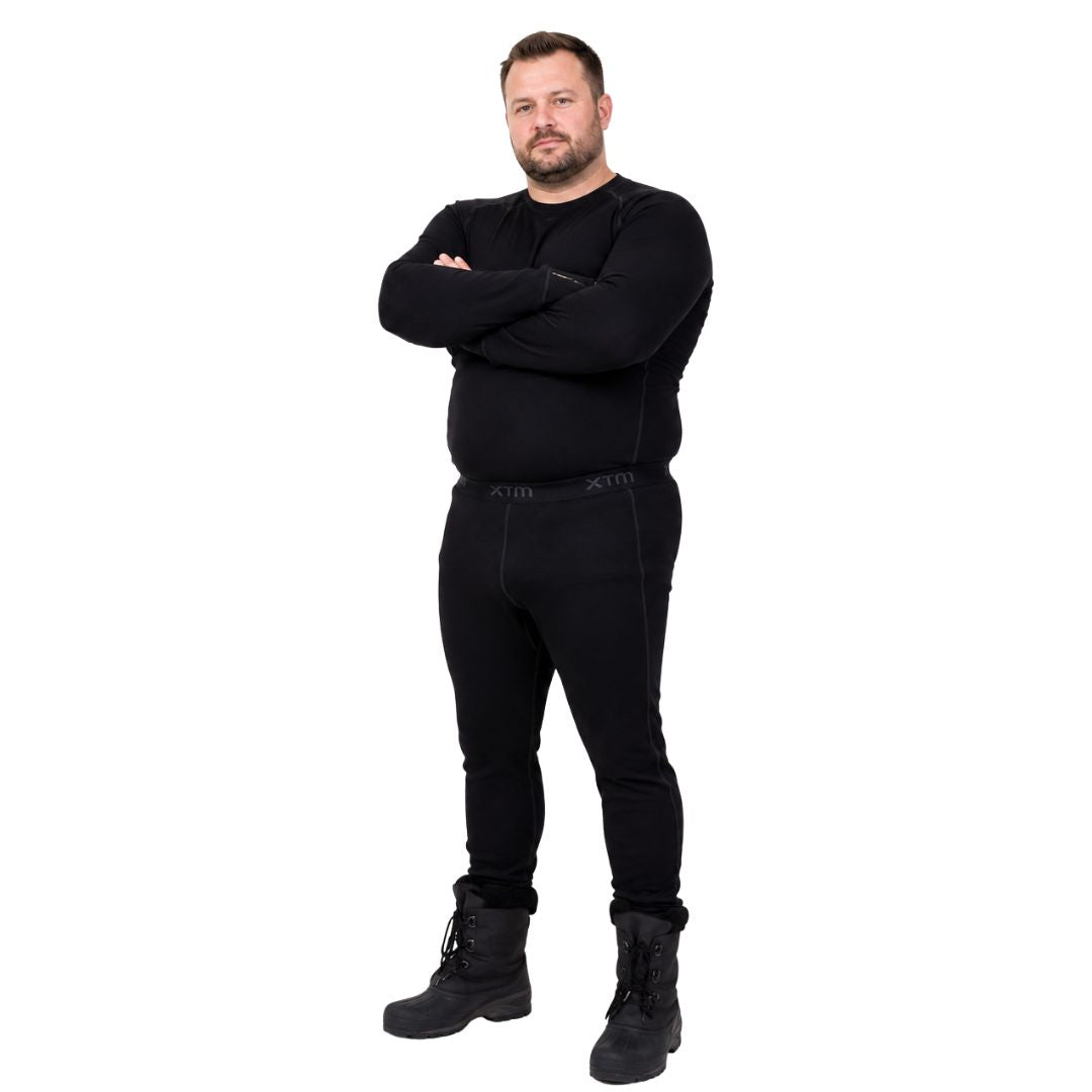 Front view of a man standing with arms crossed wearing XTM Siberia Merino Wool Unisex Plus Size Thermal Pants and matching long sleeve top in black.