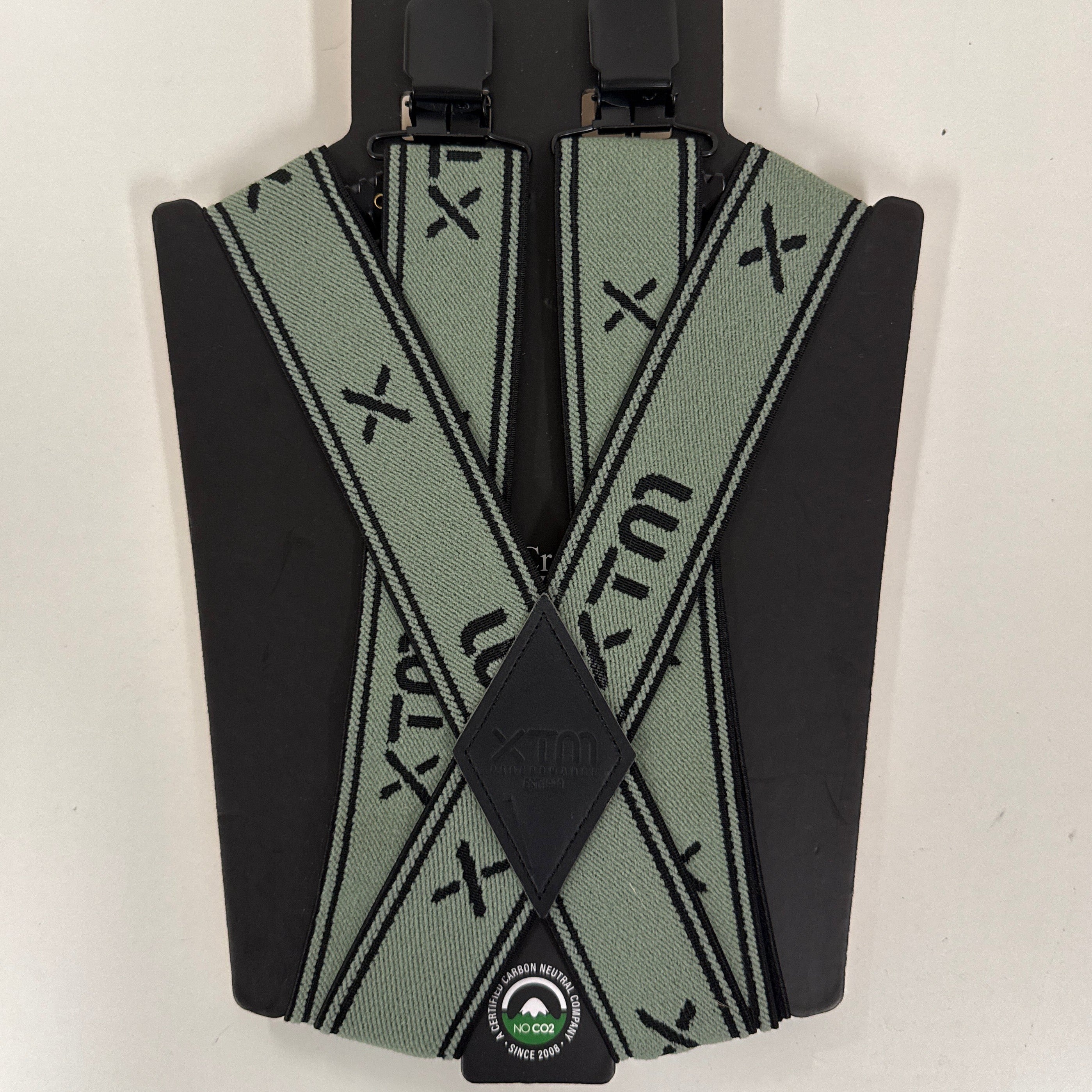 Black and green wide elastic suspenders with XTM branding on a white background