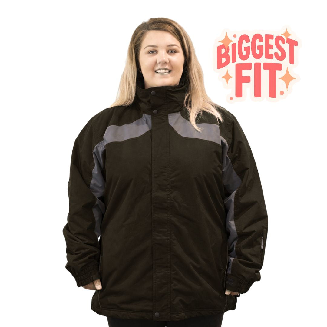 Front view of a smiling woman modeling the Aggress Treblecone Plus Size Ski Jacket in Nespresso dark brown with grey panels.