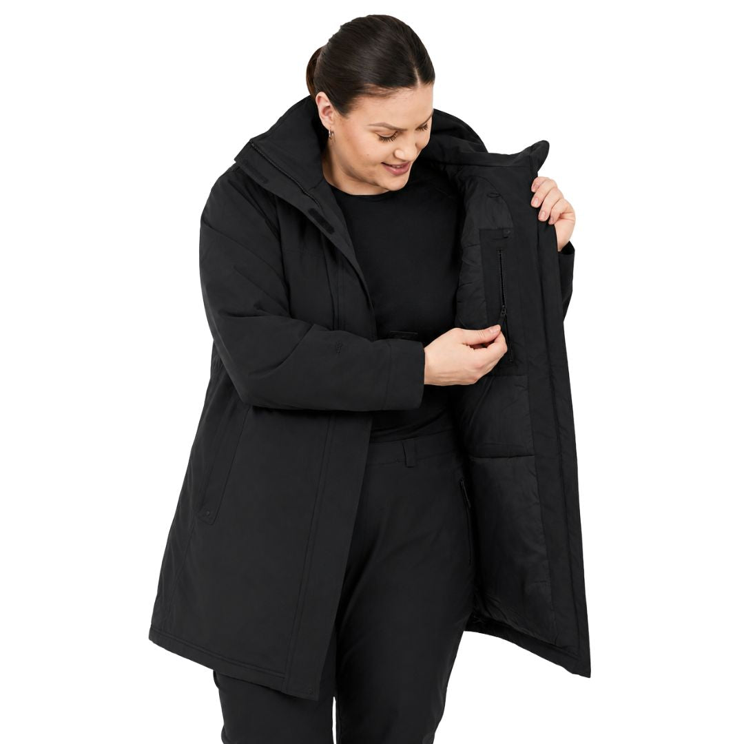 Close-up view of a woman opening the front flap to reveal the inner storage pocket zipper of the black Brooky Long Stretch Jacket.