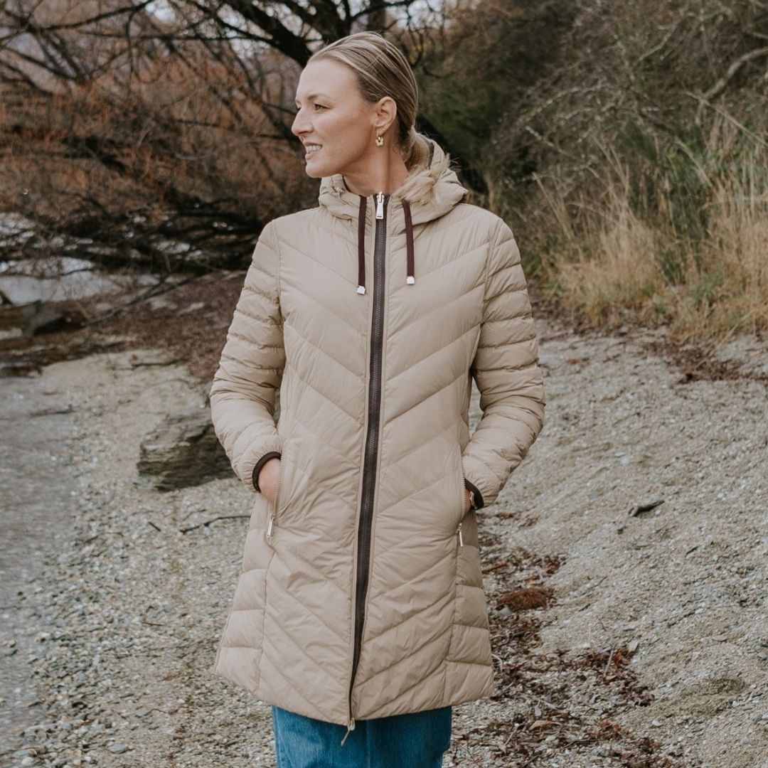 Woman wearing Plus-size Arnie Reversible Palomino Jacket looking side into the river.