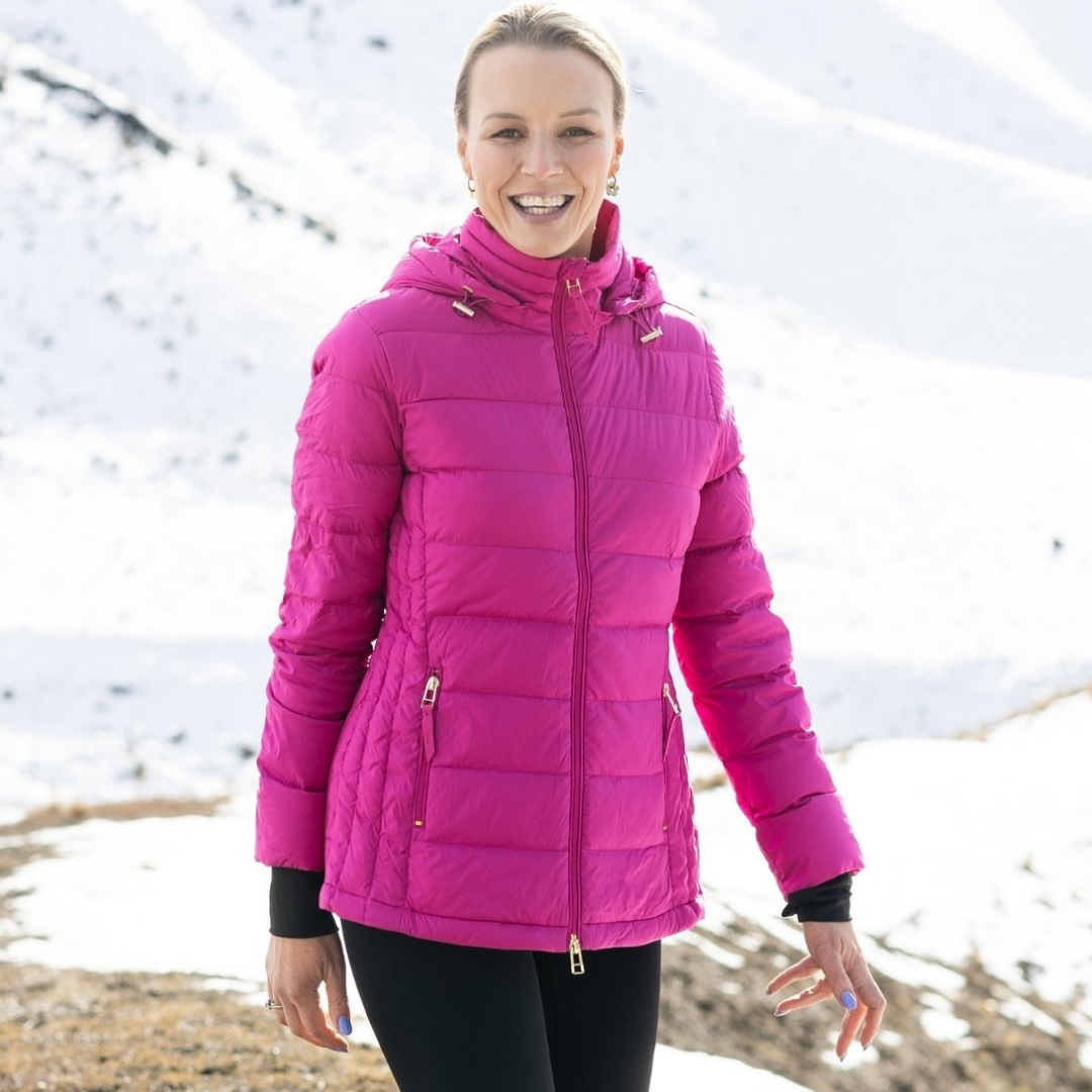 Woman standing in the snow wearing rose violet luciana Women's puffer jacket