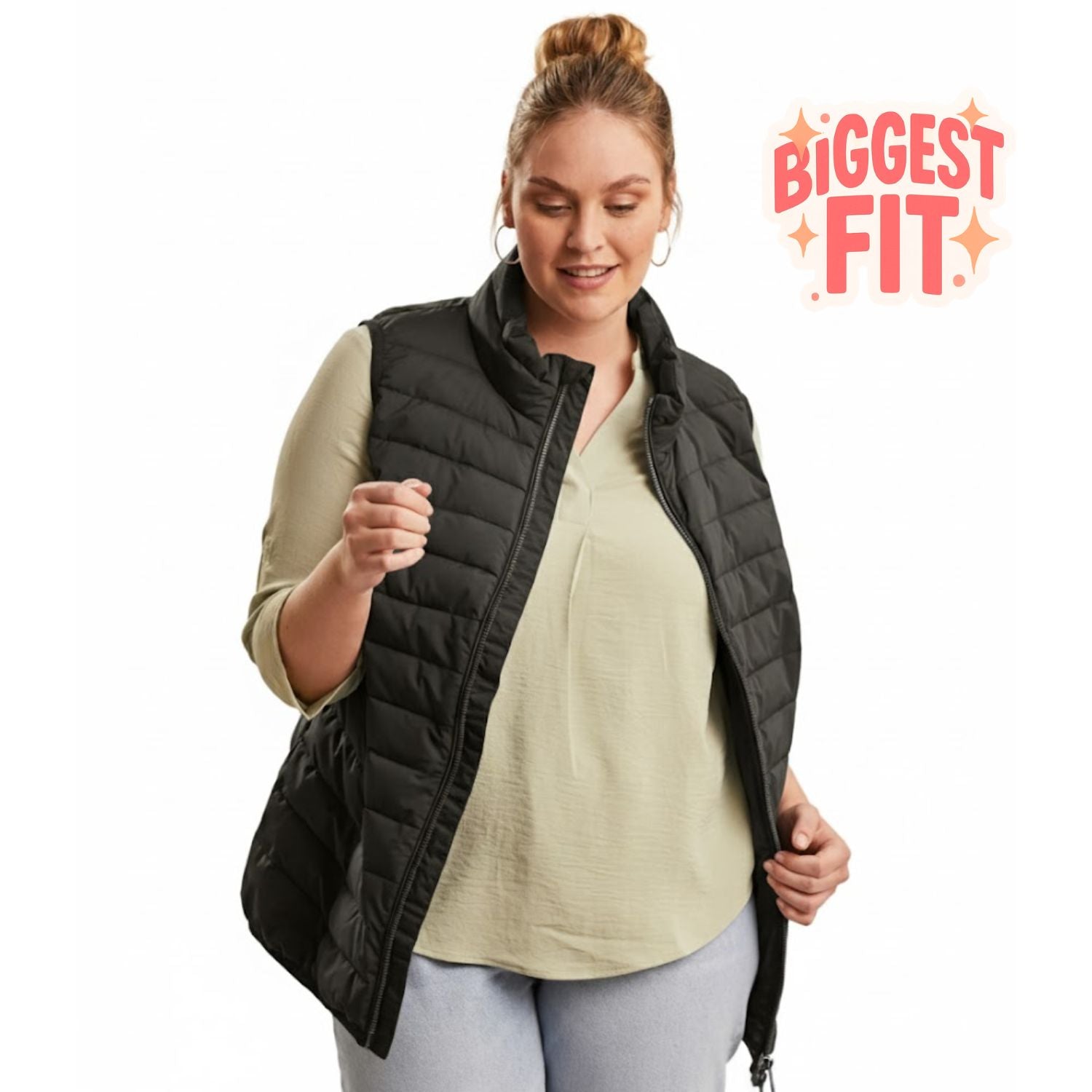 Front view of a smiling woman with a hair bun wearing the black Stoy Unisex Plus Size Puffer Vest over a sage green top.