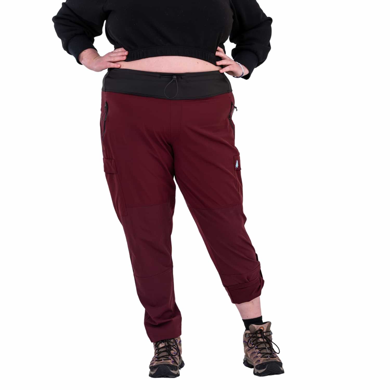 Front view of Thicket Adventure Brecken Hiking Pants BELLY FIT in burgundy, featuring adjustable waistband, zip pockets, cargo pockets, and cuffed hems in plus sizes 18-34.