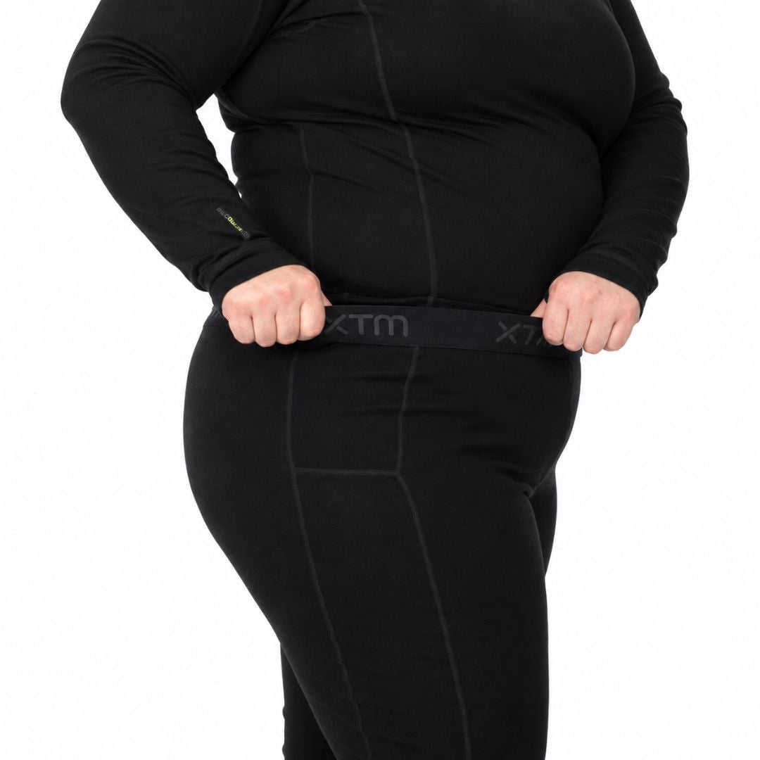 Side close up showing the stretch capability and comfort fit waistband of the XTM Siberia Merino Wool Unisex Plus Size Thermal Pants.