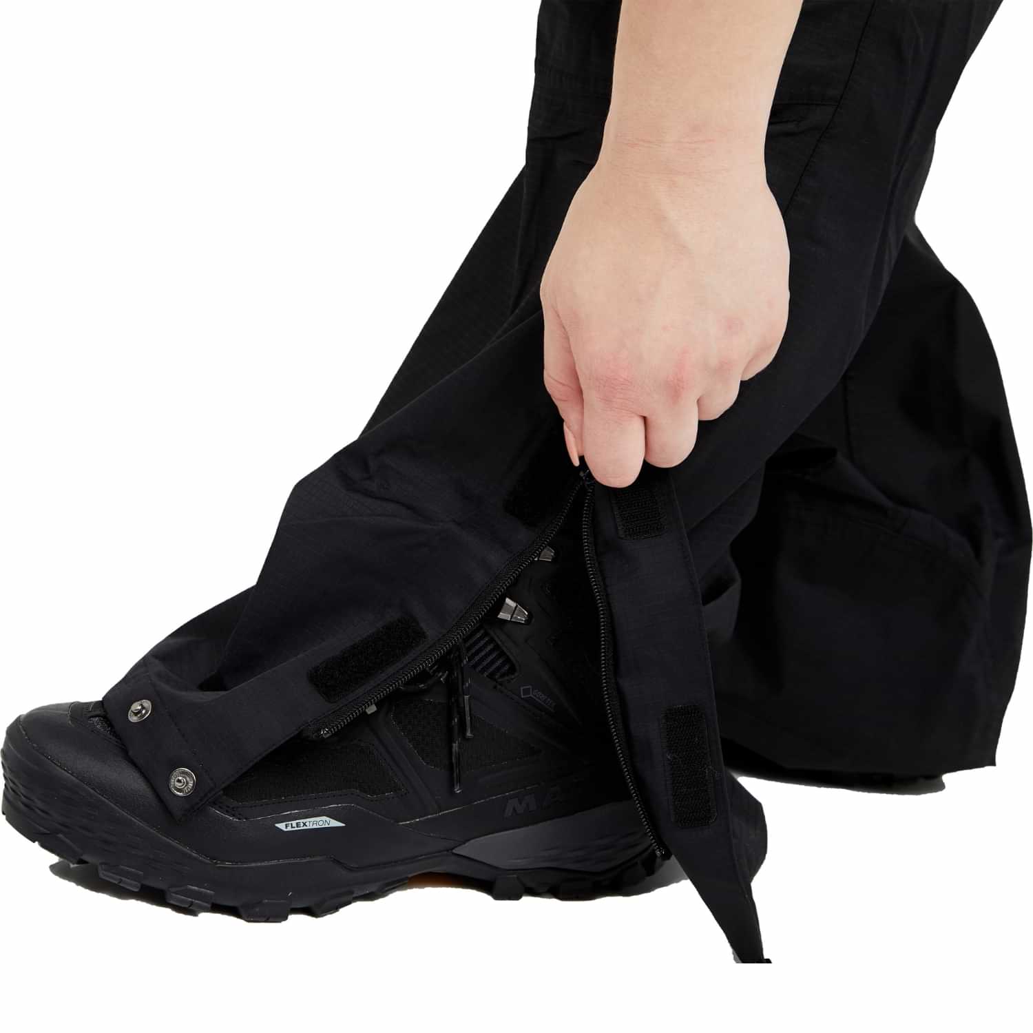 Close-up of waterproof shell rain pants over hiking boots.